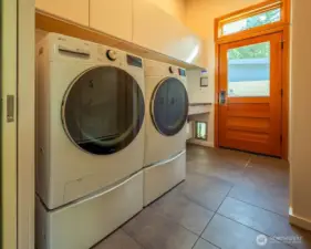 Utility room, with LG washer/dryer, folding counter, and storage and coat closets.