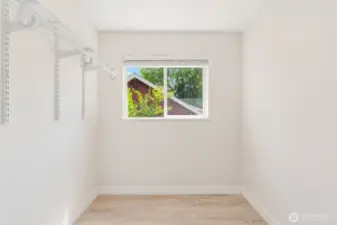 Primary suite walk-in closet with where space abounds.