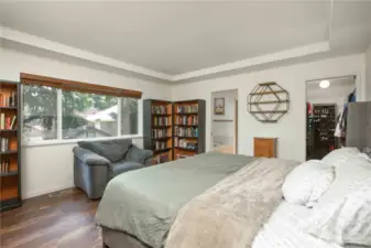 Primary suite overlooks the backyard and includes a tray ceiling.