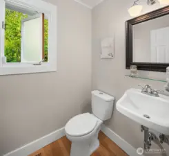 Powder room with newer baseboards and trim.