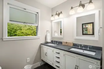 Stylish double vanity with coordinated lights and mirrors.