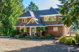 Set on 3.8+ acres of natural beauty overlooking the trees, above the inside bay of Ocean Shores, the owners have created a charming Shingle~styled home and setting that is steeped in Nantucket style.