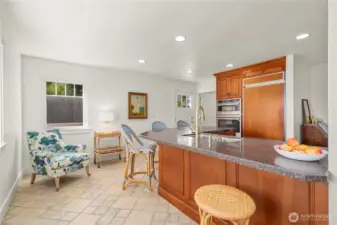 The kitchen boasts a generous island, subzero refrigerator & butler's pantry with wonderful stone tile flooring.