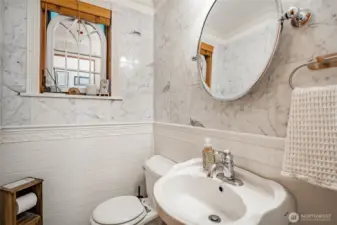 Main Floor half bathroom, tons of marble and ceramic tile