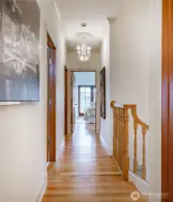 Photo taken from the 2 upstairs bedrooms. First door on the left is the full bathroom. Second door on the left is the Laundry Room. and at the end is the upstairs Primary Suite.