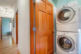 Laundry room. Looking back toward bedrooms 1&2. Stairs to the left and primary suite behind.