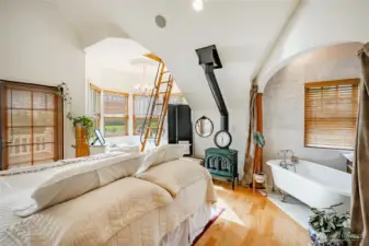 Large Primary suite with attached full bathroom and stairs leading to the 3rd floor nook. Gas freestanding gas stove for that added warmth. Light and bright and south facing.