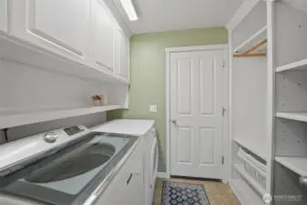 Main level laundry and mud room with built in shelves