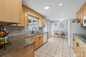 Kitchen with updates like maple cabinets, granit counters and tile floors