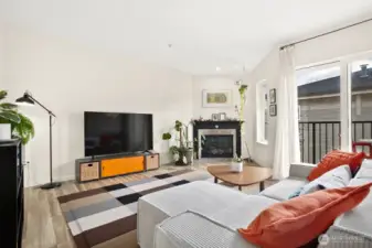 Living room with upgraded fireplace, and access to private balcony