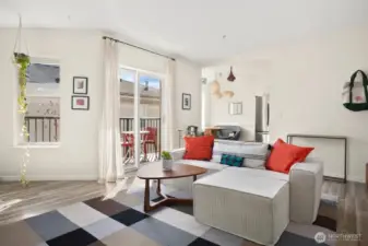 Living room looking to dining nook and sliding glass door leading to balcony
