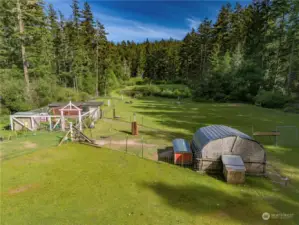 Partially fenced with some livestock shelters previously used for sheep, llama, and ducks