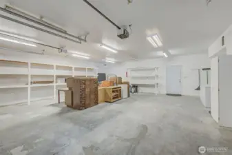 966 sq foot heated shop. Lots of shelving and also 1/2 bath in shop. Door to the back yard is straight ahead. There's also another door from the old laundry room to the back yard.