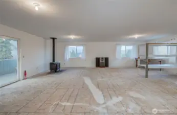 HUGE upstairs bonus room with woodstove and lots of natural light.