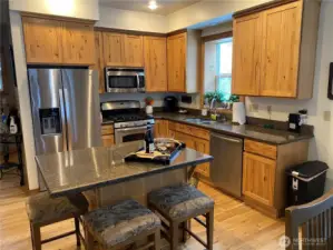 Full kitchen with hickory cabinets, stainless appliances and granite counters. Hickory cabinets add to the cabin feel.