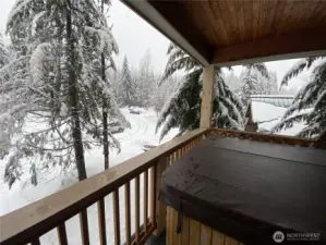 Hot tub on main deck. This amenity enhances the property's relaxation and entertainment features, providing a luxurious outdoor experience.