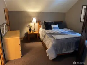 Upper level master bedroom - view of secondary queen bed on the other side of the room with divider.