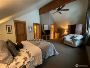 Master bedroom located on upper level with two queen beds.