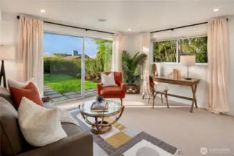 Versatile lower-level living 5th bedroom or potential media room, guest retreat or home office, with direct access to the backyard.