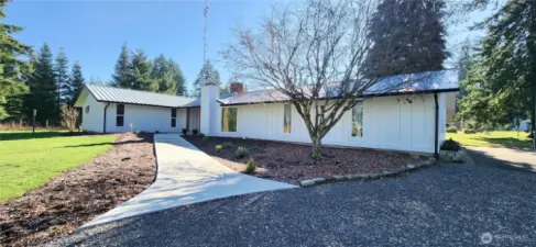 Another view of your great sized rambler with ADU. Main home entry along newly poured concrete path. ADU entry around home under carport to the right.
