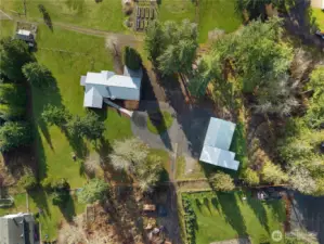 Overhead shot of your 2+ acre private property. Flat & level lot with tons of space for gardening or outdoor activities. Main home and ADU on left, large 2,000+ sqft shop with 5 bays and framed out additional room, full electric and water available in shop.