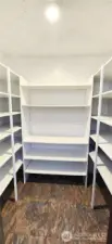 Full sized walk in pantry with built in shelving and storage space. An abundance of storage exists in this kitchen.