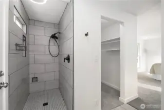 Beautiful floor to ceiling tiled walk in shower with multiple built in storage nooks. High end finished and LED lighting in shower with built in speaker and night light function. One of two walk in closets lies directly next to shower for ease and convenience.