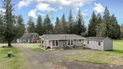 View of front of property - Main house with one of the storage sheds, guest house behind with apartment above.