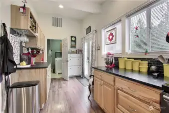 View from kitchen toward back patio door and utility room.