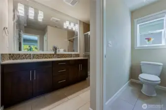 Master bath is an ensuite with separate water closet, double vanity, walk-in closet, walk-in shower. Tiled floors and shower, mosaic backsplash, quartz countertop, soft close cabinetry.