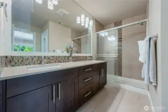 Master bath shower with ceiling to floor tiles. Gas tankless water heater provides instant, steamy hot shower!