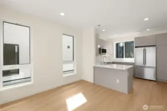 Photos of model home with similar finishes & floor plan.Modern kitchen layout with peninsula seating, sleek cabinetry, and stainless steel accents.