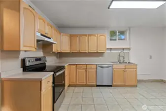 This well-designed kitchen offers a functional layout with plenty of counter and cabinet space and modern stainless steel appliances.