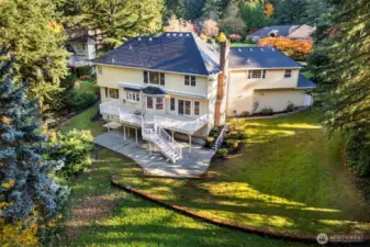 Backside of home features 450 sqft deck and even larger dry patio below.