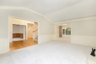Third view of living room with entry and den to the left and formal dining room directly ahead.