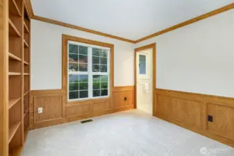 Den off the main entry with access to the main floor 3/4 bath in the background.    Yes, built-in shelving here too.   This house has it all!