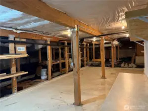 Huge high ceiling space accessed via patio double doors.    Incredible shop space plus storage or potential additional finished space.   Buyer to verify.