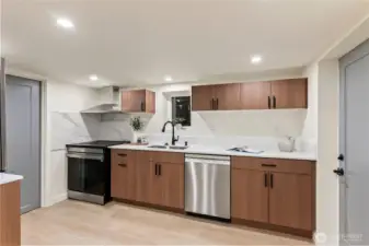 Full size kitchen in basement area.