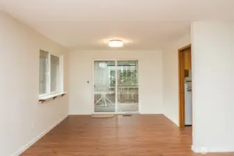 Dining area with sliding glass door to back deck and pocket door into the kitchen.