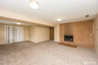 Daylight basement with fireplace plumbed for gas, new carpet, light fixtures and blinds and freshly painted.  Glass sliding door to patio and back yard.