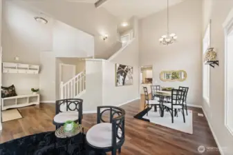 The living room welcomes you with LVP hardwood flooring and high ceilings that create a bright, open feel.