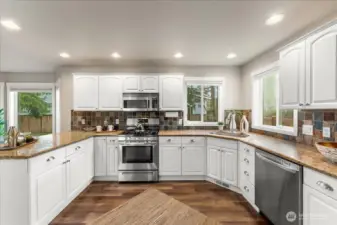 The kitchen features granite countertops that provide both style and durability, offering plenty of prep space for everyday cooking and entertaining. Abundant cabinetry and storage throughout the kitchen provide excellent organization and functionality.