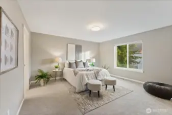 The primary bedroom is spacious and serene, offering a comfortable retreat at the end of the day.