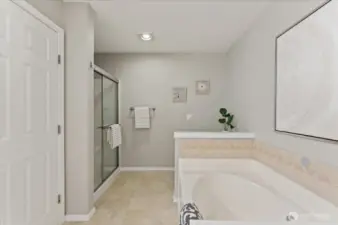 A separate shower and deep soaking tub create a relaxing retreat.