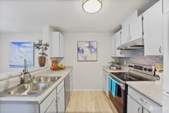 Galley styled kitchen with generous storage and newer appliances.