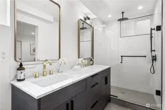 Luxurious dual vanity with contemporary fixtures and a walk-in rain shower.