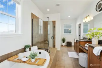 Luxury primary bath with soaking tub, frameless glass shower and dual vanities