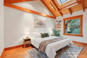 Master bedroom boasts a skylight on the vaulted ceiling.