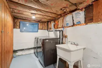 Utility sink situated next to the washer and dryer.