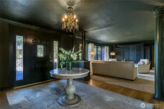 The gracious entry foyer and formal sitting area welcomes you in with chic custom color and designer wallpaper.